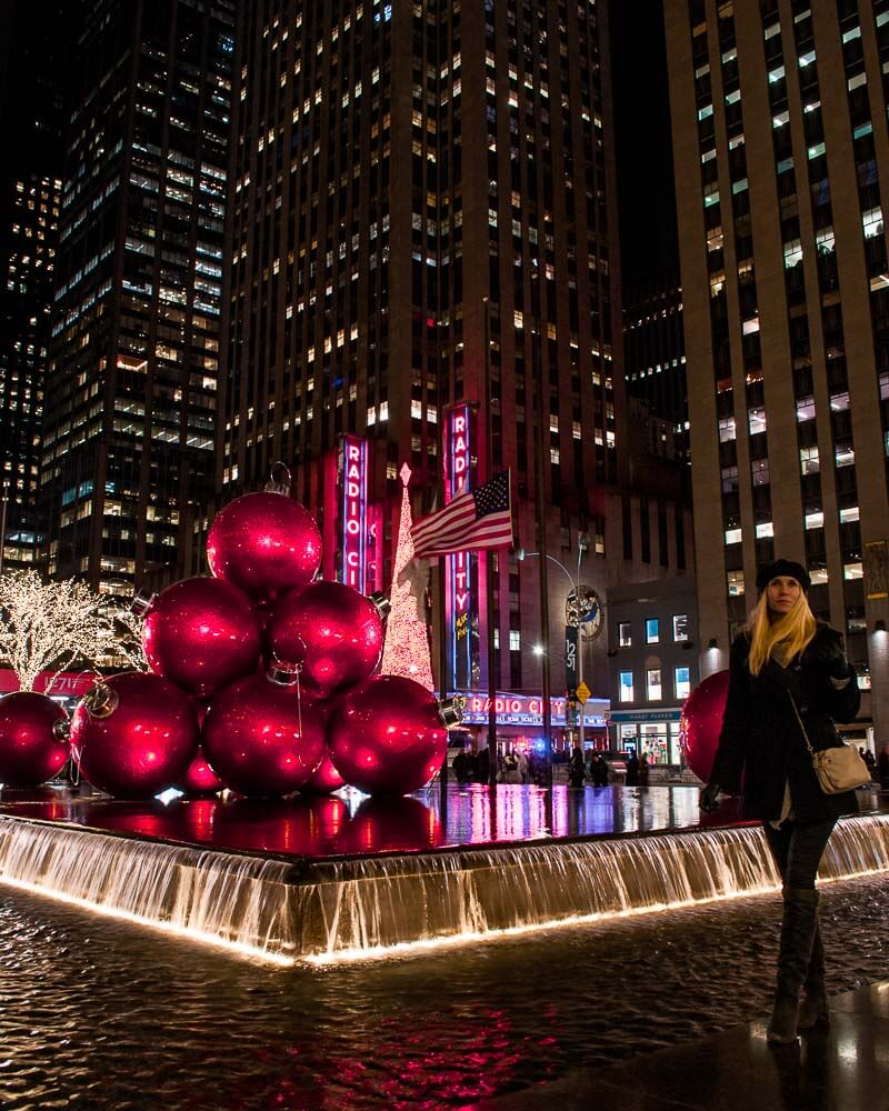 dancing between giant Christmas balls in front of radio city music hall